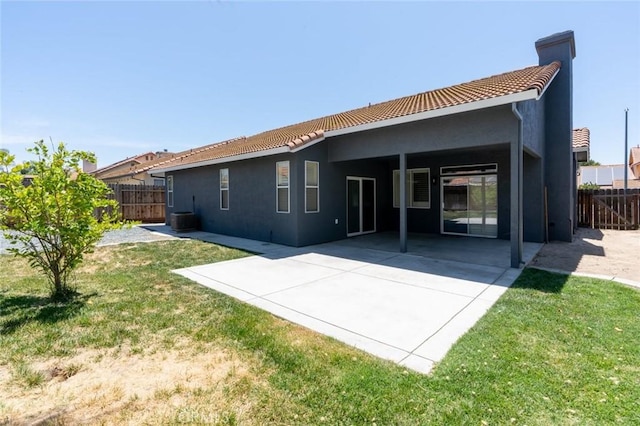 658 Tusky Ave, Los Banos, CA 93635 - rear view of house featuring a tile roof, stucco siding, a patio area, and a chimney