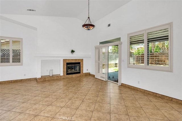 658 Tusky Ave, Los Banos, CA 93635 - unfurnished living room with a tile fireplace, light tile patterned floors, and high vaulted ceiling