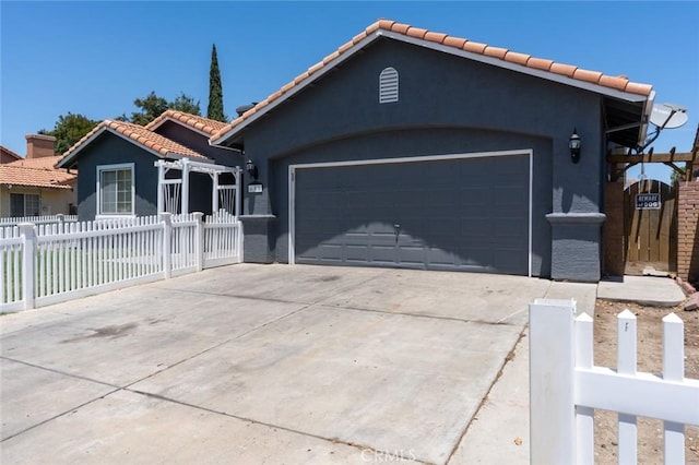 658 Tusky Ave, Los Banos, CA 93635 - view of front of home with a tile roof, stucco siding, driveway, and an attached garage