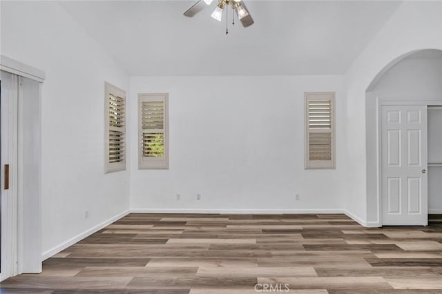 658 Tusky Ave, Los Banos, CA 93635 - unfurnished room with ceiling fan, arched walkways, and wood finished floors