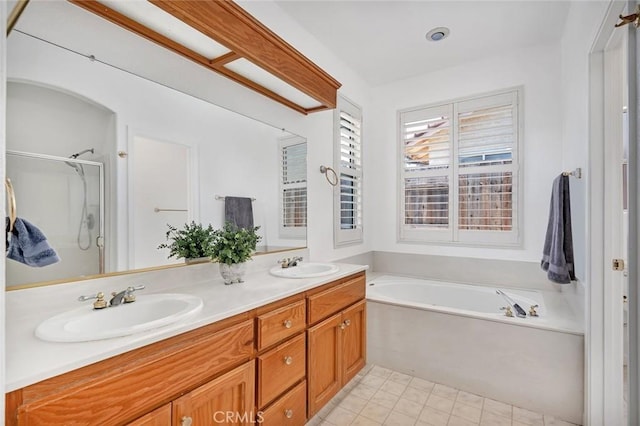 658 Tusky Ave, Los Banos, CA 93635 - bathroom featuring a garden tub, double vanity, and a shower stall