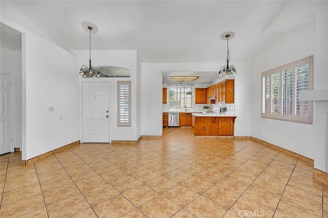 658 Tusky Ave, Los Banos, CA 93635 - kitchen featuring a chandelier, stainless steel dishwasher, light countertops, brown cabinets, and a peninsula