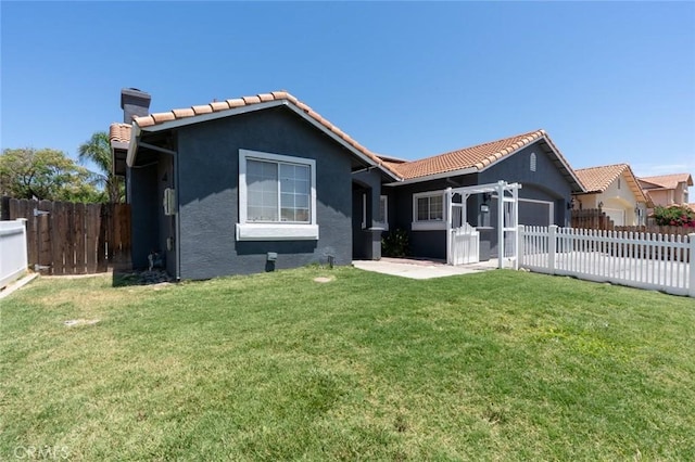 658 Tusky Ave, Los Banos, CA 93635 - rear view of house featuring a garage, stucco siding, a tiled roof, and driveway