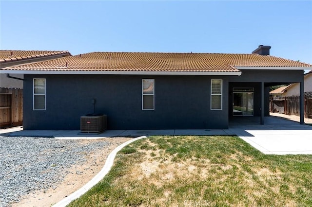 658 Tusky Ave, Los Banos, CA 93635 - rear view of house with a tile roof, stucco siding, a patio area, and a chimney