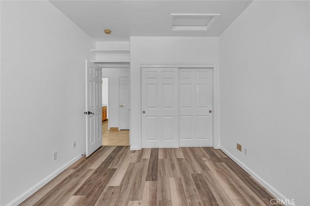 658 Tusky Ave, Los Banos, CA 93635 - unfurnished bedroom with attic access, wood finished floors, and a closet