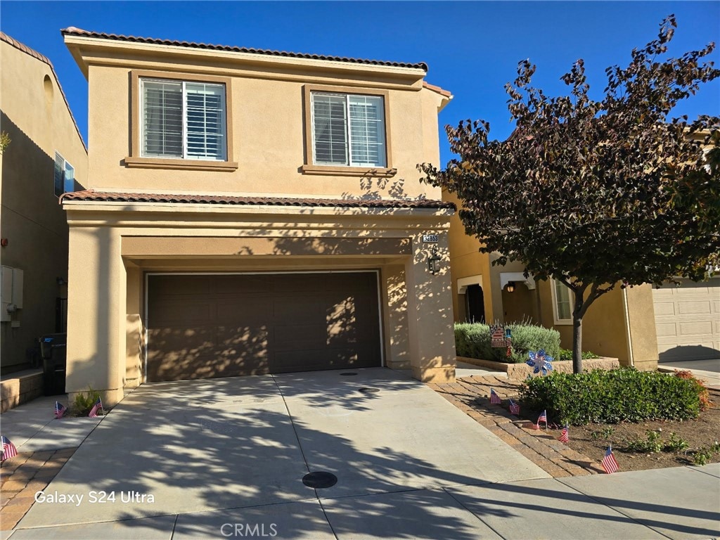 33853 Cansler Way, Yucaipa, CA 92399 - mediterranean / spanish house with an attached garage, stucco siding, concrete driveway, and a tiled roof