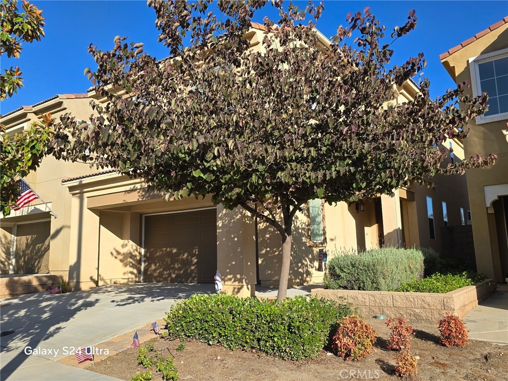 33853 Cansler Way, Yucaipa, CA 92399 - view of front of house with stucco siding, driveway, and a garage