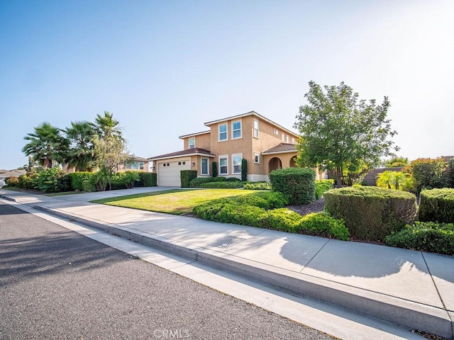 9275 Serenity St, Riverside, CA 92508 - traditional-style house featuring an attached garage, stucco siding, concrete driveway, and a front lawn