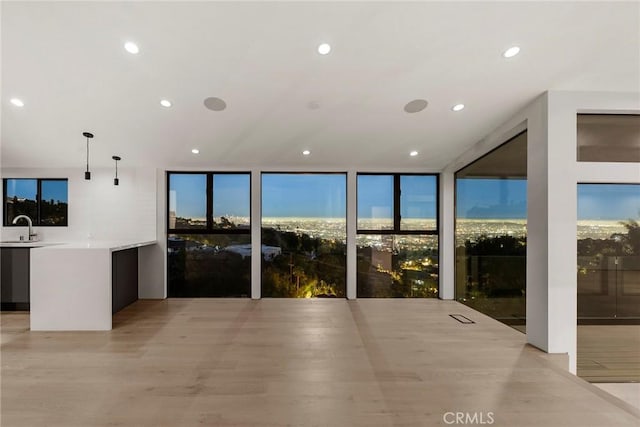 9336 Lloydcrest Dr, Beverly Hills, CA 90210 - kitchen with recessed lighting, floor to ceiling windows, light countertops, pendant lighting, and modern cabinets