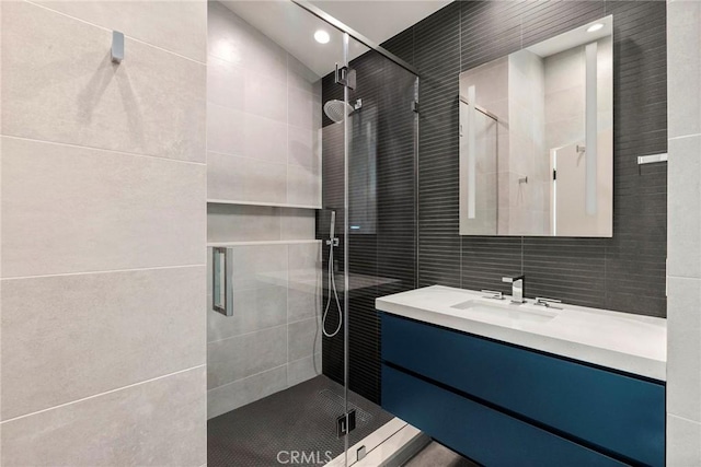 9336 Lloydcrest Dr, Beverly Hills, CA 90210 - full bathroom featuring tile walls, vanity, a stall shower, and recessed lighting