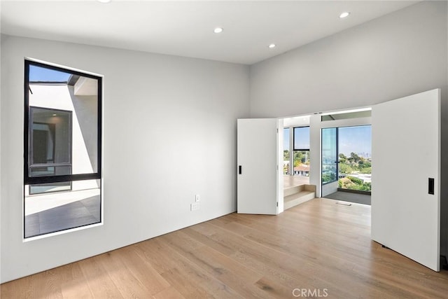 9336 Lloydcrest Dr, Beverly Hills, CA 90210 - spare room with wood finished floors, recessed lighting, and a high ceiling