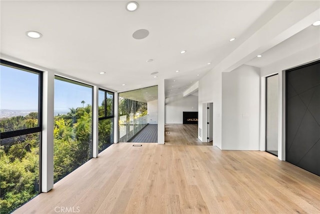 9336 Lloydcrest Dr, Beverly Hills, CA 90210 - spare room with plenty of natural light, recessed lighting, floor to ceiling windows, and light wood-style flooring