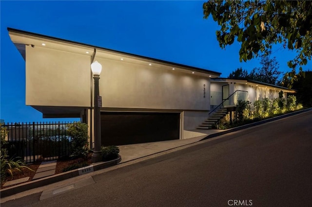 9336 Lloydcrest Dr, Beverly Hills, CA 90210 - view of front of house with a garage, stairs, and stucco siding