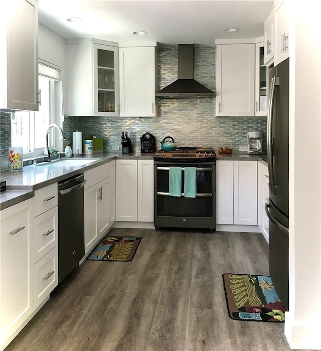2577 Plaza Del Amo Unit 712, Torrance, CA 90503 - kitchen featuring stainless steel appliances, wall chimney exhaust hood, backsplash, white cabinets, and recessed lighting