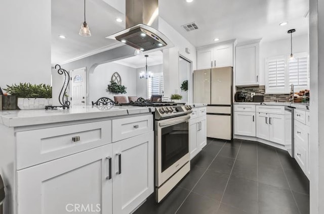 4708 W 132nd St, Hawthorne, CA 90250 - kitchen featuring island range hood, stainless steel gas stove, freestanding refrigerator, ornamental molding, and backsplash