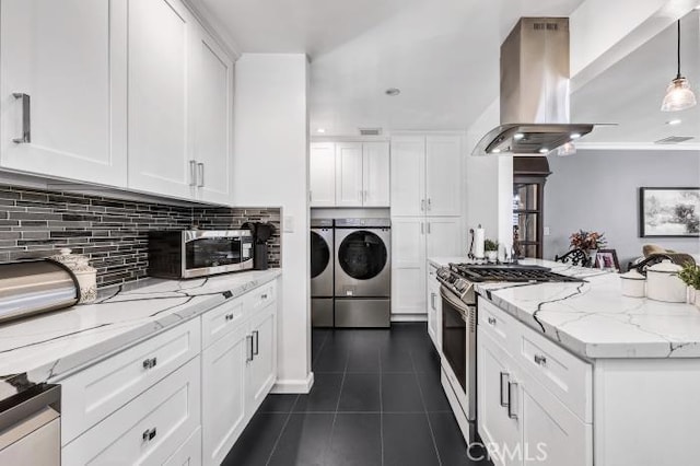 4708 W 132nd St, Hawthorne, CA 90250 - kitchen featuring washer and clothes dryer, island range hood, stainless steel appliances, dark tile patterned floors, and backsplash