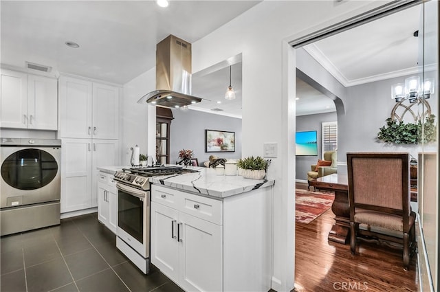 4708 W 132nd St, Hawthorne, CA 90250 - kitchen with stainless steel gas range oven, island exhaust hood, washer / clothes dryer, crown molding, and light stone counters