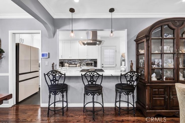 4708 W 132nd St, Hawthorne, CA 90250 - kitchen with freestanding refrigerator, extractor fan, a kitchen breakfast bar, crown molding, and decorative backsplash