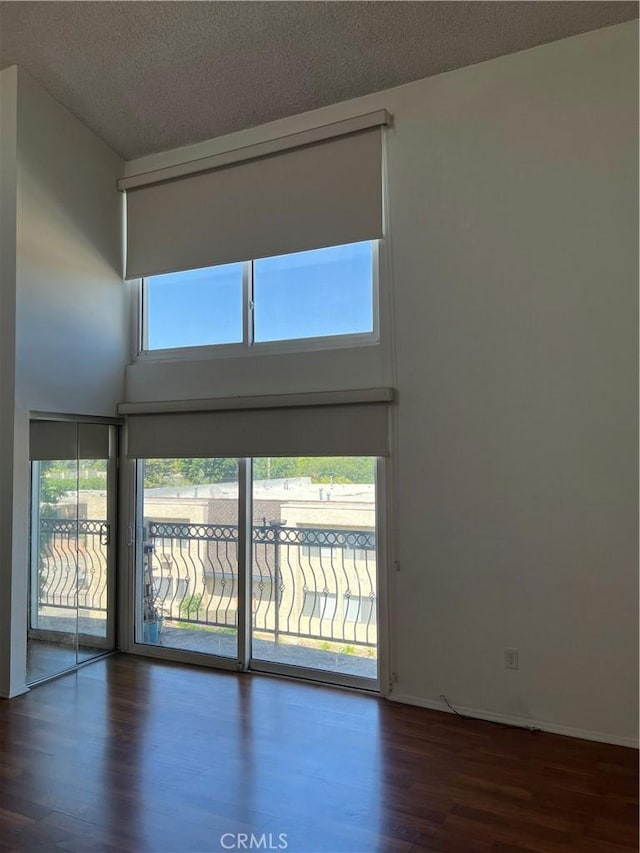 5257 Radford Ave Unit 308, Valley Village, CA 91607 - spare room with wood finished floors, a towering ceiling, and a textured ceiling