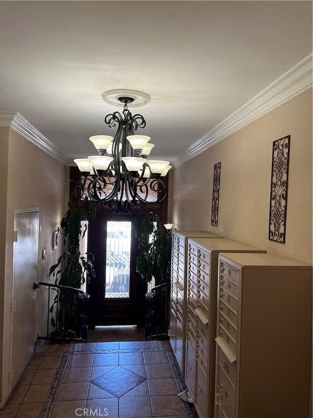 5257 Radford Ave Unit 308, Valley Village, CA 91607 - entrance foyer with inlaid floor details, a chandelier, ornamental molding, and dark tile patterned floors
