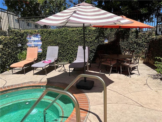 5257 Radford Ave Unit 308, Valley Village, CA 91607 - view of swimming pool featuring a community hot tub, a patio area, and outdoor dining space