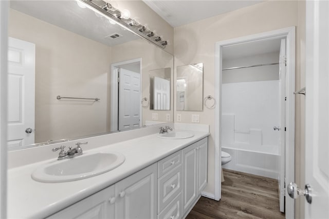 45339 Tiburcio Dr, Temecula, CA 92592 - bathroom with double vanity, wood finished floors, and tub / shower combination