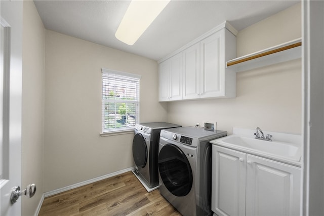 45339 Tiburcio Dr, Temecula, CA 92592 - laundry area with cabinet space, washer and dryer, and light wood-style flooring