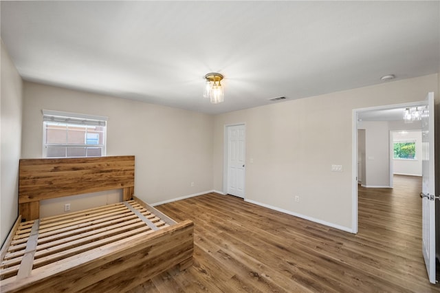 45339 Tiburcio Dr, Temecula, CA 92592 - unfurnished bedroom featuring wood finished floors and multiple windows
