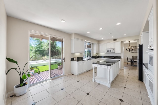 45339 Tiburcio Dr, Temecula, CA 92592 - kitchen featuring white appliances, dark countertops, healthy amount of natural light, a chandelier, and recessed lighting
