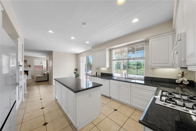 45339 Tiburcio Dr, Temecula, CA 92592 - kitchen featuring white appliances, a center island, recessed lighting, white cabinets, and light tile patterned floors