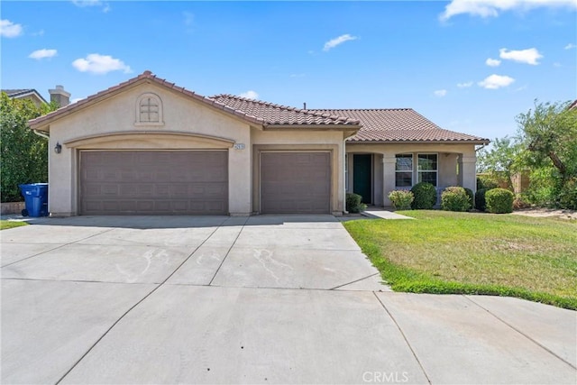 42619 Meridian Way, Lancaster, CA 93536 - mediterranean / spanish-style home with a garage, stucco siding, concrete driveway, and a front lawn
