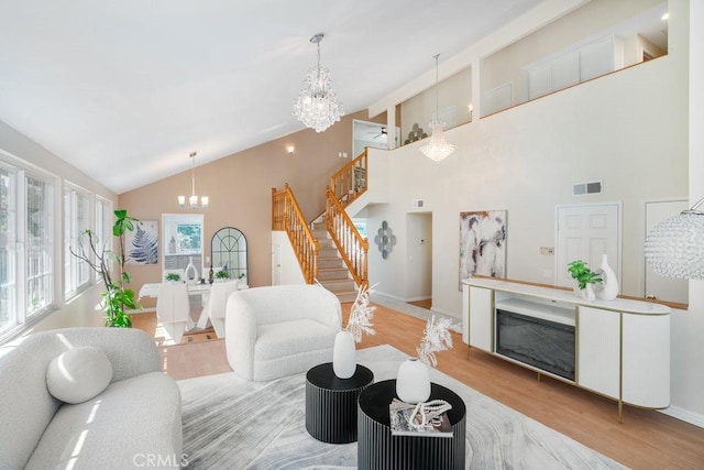 20329 Rim Ridge Rd, Walnut, CA 91789 - living area with a chandelier, stairs, wood finished floors, high vaulted ceiling, and a fireplace