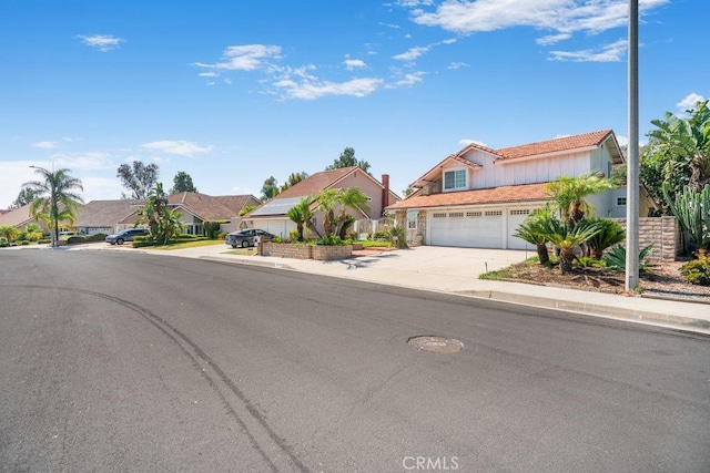 20329 Rim Ridge Rd, Walnut, CA 91789 - view of front facade with concrete driveway, a residential view, an attached garage, and a tile roof