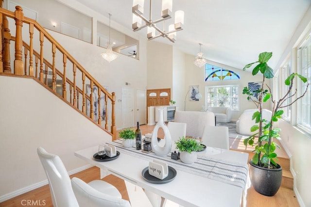 20329 Rim Ridge Rd, Walnut, CA 91789 - dining room featuring a chandelier, high vaulted ceiling, wood finished floors, and stairway