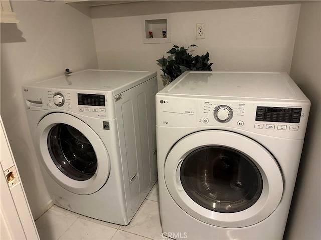 20329 Rim Ridge Rd, Walnut, CA 91789 - laundry room with washer and clothes dryer and light marble finish floors