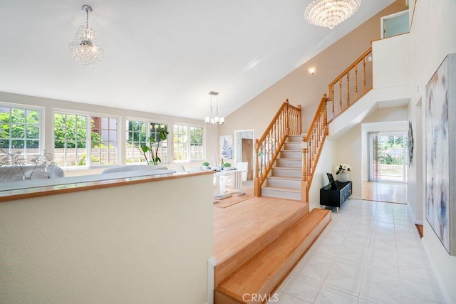 20329 Rim Ridge Rd, Walnut, CA 91789 - stairway featuring a chandelier, plenty of natural light, high vaulted ceiling, and tile patterned floors