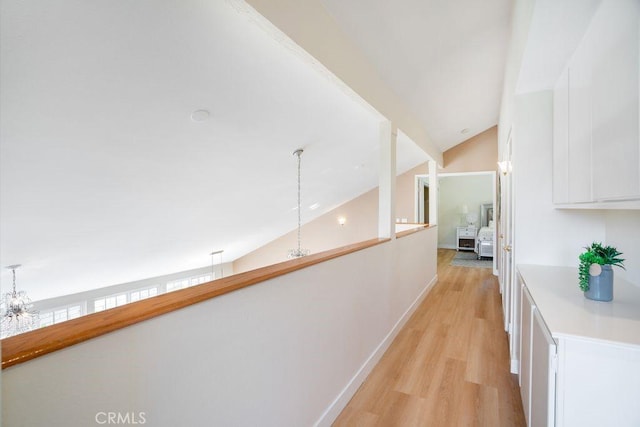 20329 Rim Ridge Rd, Walnut, CA 91789 - corridor with light wood-type flooring, a chandelier, and vaulted ceiling