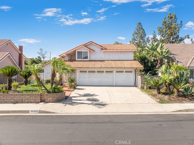 20329 Rim Ridge Rd, Walnut, CA 91789 - view of front of property featuring a tiled roof, driveway, and an attached garage