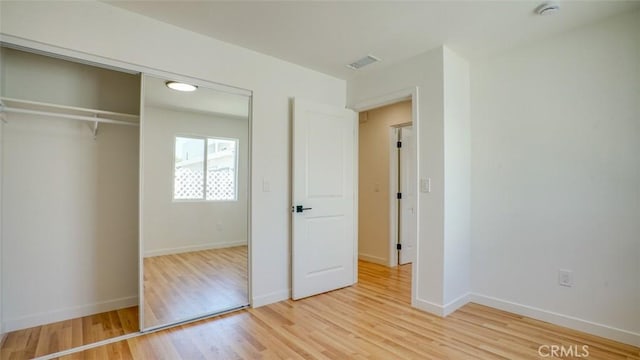 856 W 47th St, Los Angeles, CA 90037 - unfurnished bedroom featuring light wood-style floors and a closet