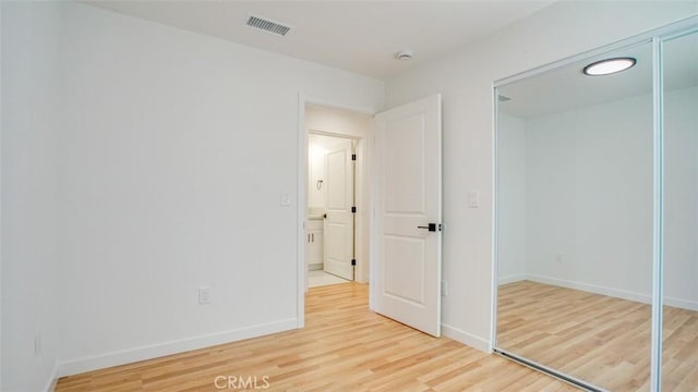 856 W 47th St, Los Angeles, CA 90037 - unfurnished bedroom with light wood finished floors and a closet