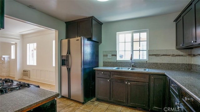 856 W 47th St, Los Angeles, CA 90037 - kitchen with refrigerator with ice dispenser, tasteful backsplash, black gas cooktop, light tile patterned floors, and dark countertops