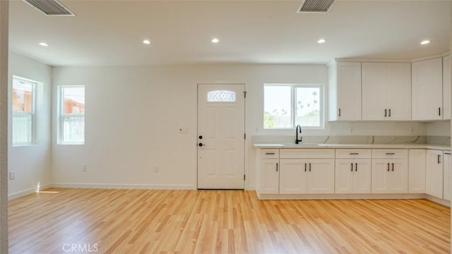 856 W 47th St, Los Angeles, CA 90037 - kitchen featuring light wood-style flooring, light countertops, white cabinetry, and recessed lighting