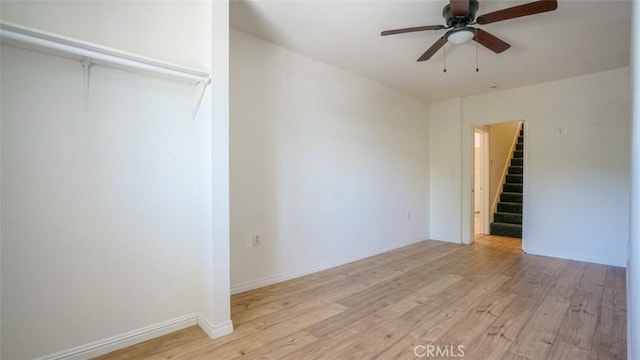 856 W 47th St, Los Angeles, CA 90037 - unfurnished room featuring light wood finished floors, ceiling fan, and stairway