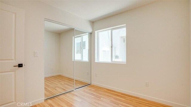 856 W 47th St, Los Angeles, CA 90037 - unfurnished bedroom with wood finished floors and a closet