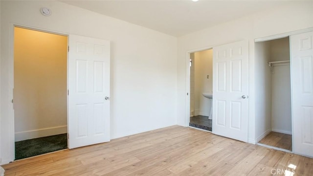 856 W 47th St, Los Angeles, CA 90037 - unfurnished bedroom featuring wood finished floors and a closet
