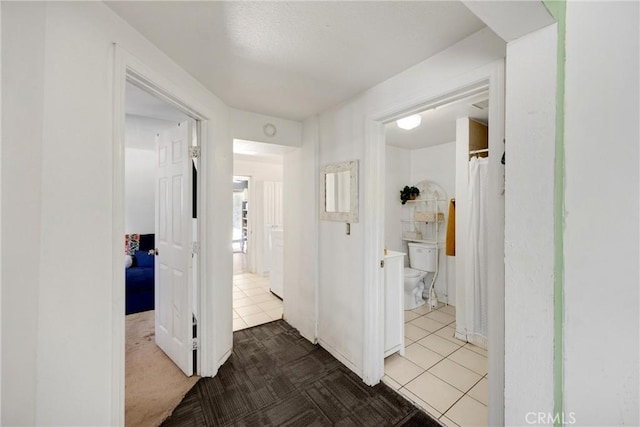 1003 Stevenson St, Colton, CA 92324 - corridor featuring tile patterned flooring and carpet flooring