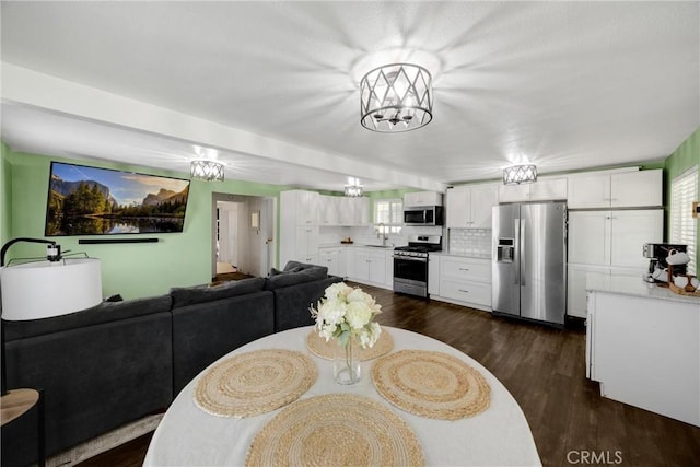 1003 Stevenson St, Colton, CA 92324 - dining space with dark wood-style floors and a chandelier