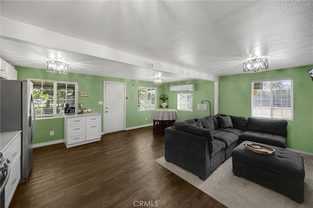 1003 Stevenson St, Colton, CA 92324 - living room with dark wood-style flooring, healthy amount of natural light, a textured ceiling, and a wall mounted AC