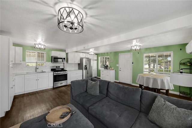 1003 Stevenson St, Colton, CA 92324 - living area with a chandelier, dark wood-type flooring, and healthy amount of natural light