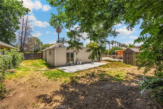 1003 Stevenson St, Colton, CA 92324 - back of house featuring a patio area, a fenced backyard, and a storage shed